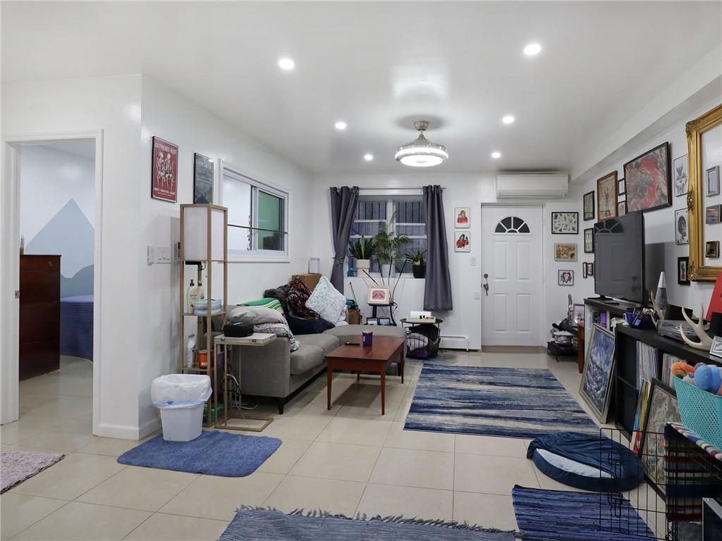 643 Morgan Avenue Brooklyn, NY 11222 - Photo 13 of 50 a living room with furniture and a flat screen tv