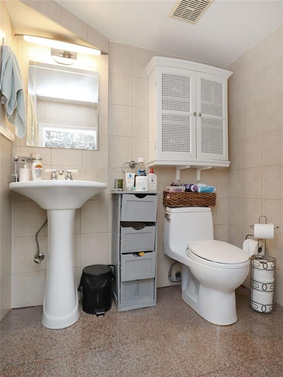 643 Morgan Avenue Brooklyn, NY 11222 - Photo 16 of 50 a bathroom with a sink toilet and window