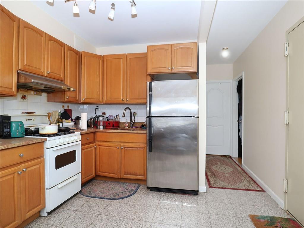 643 Morgan Avenue Brooklyn, NY 11222 - Photo 24 of 50 a kitchen with stainless steel appliances granite countertop a refrigerator and a stove top oven