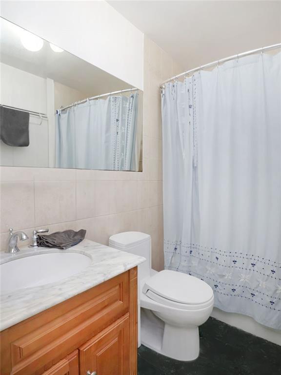 643 Morgan Avenue Brooklyn, NY 11222 - Photo 26 of 50 a bathroom with a sink a toilet and shower