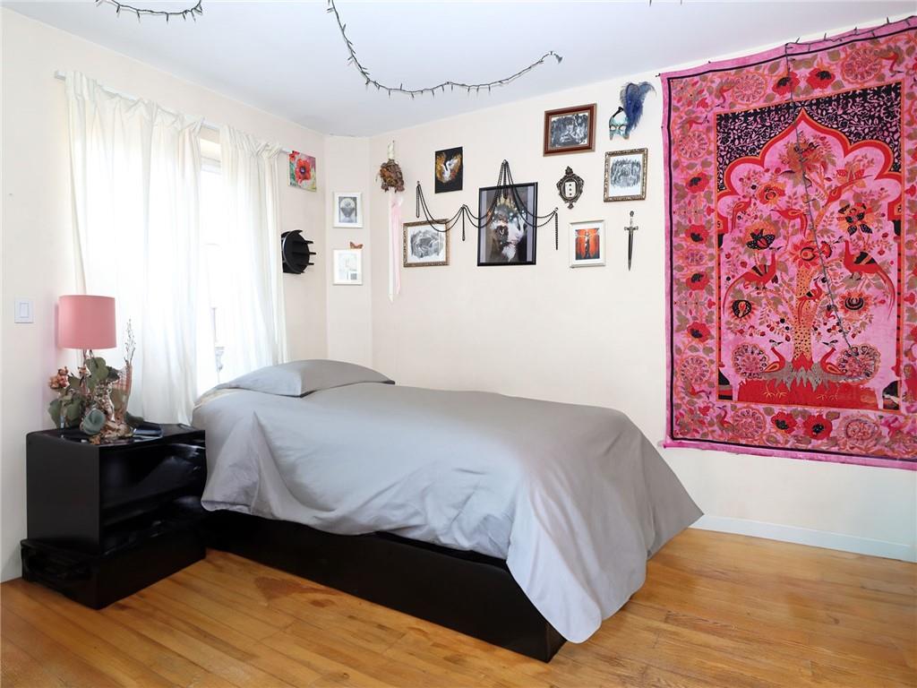 643 Morgan Avenue Brooklyn, NY 11222 - Photo 27 of 50 a bedroom with a bed and wooden floor