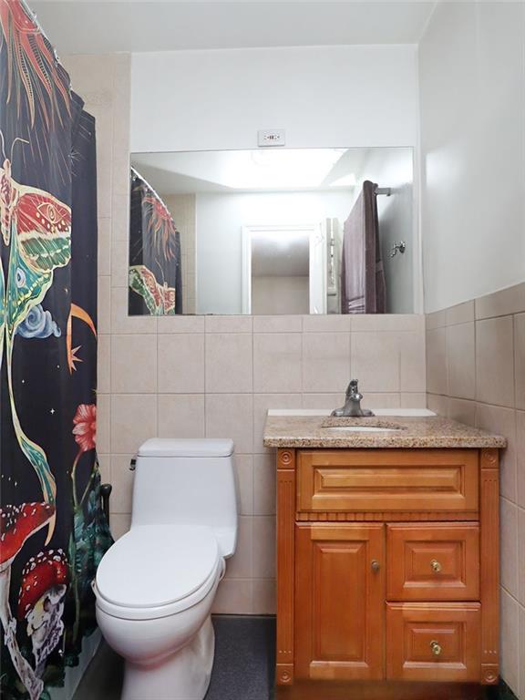 643 Morgan Avenue Brooklyn, NY 11222 - Photo 28 of 50 a bathroom with a granite countertop toilet sink and mirror