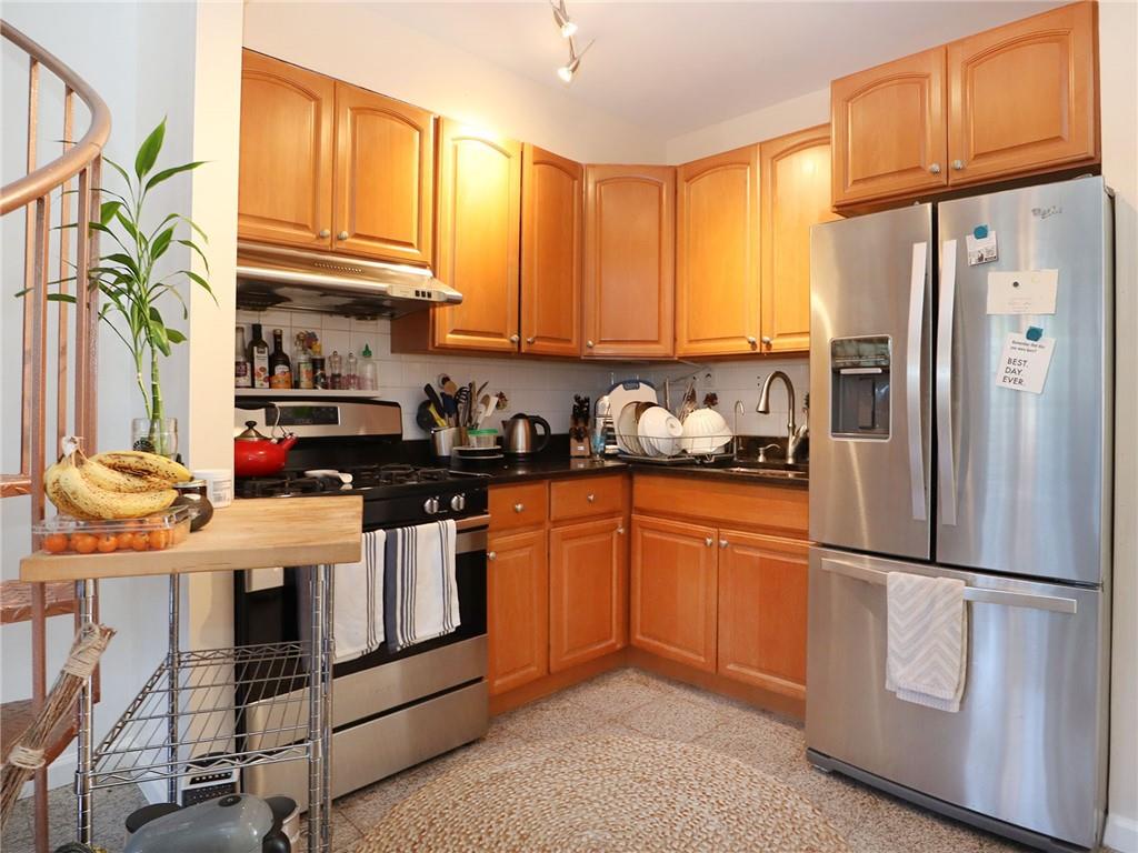 643 Morgan Avenue Brooklyn, NY 11222 - Photo 34 of 50 a kitchen with stainless steel appliances granite countertop a refrigerator a stove and a sink with cabinets