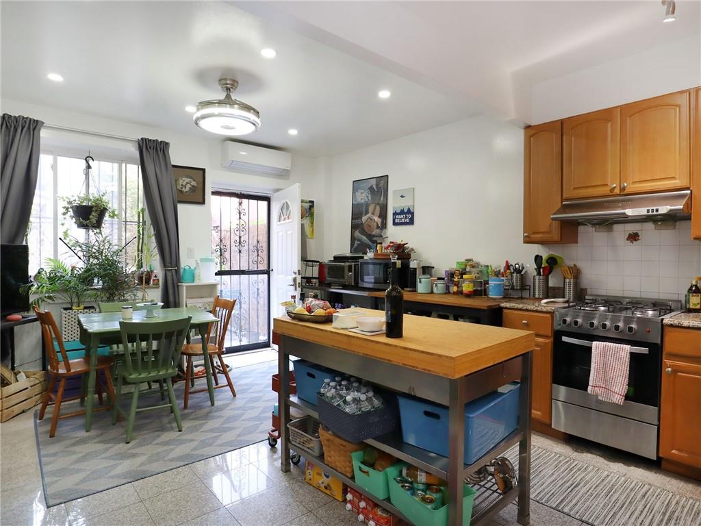 643 Morgan Avenue Brooklyn, NY 11222 - Photo 5 of 50 a kitchen with stainless steel appliances granite countertop a stove top oven a sink dishwasher and cabinets with wooden floor