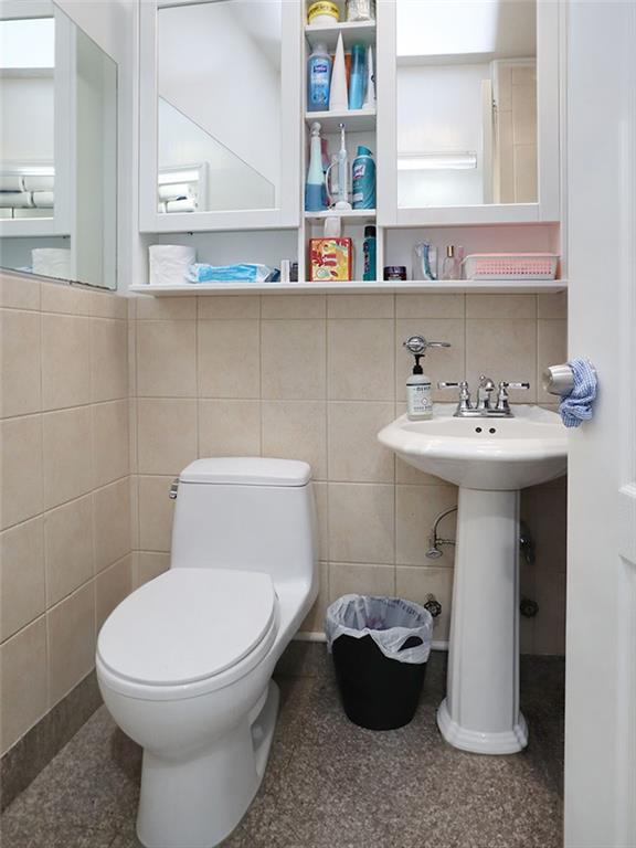 643 Morgan Avenue Brooklyn, NY 11222 - Photo 7 of 50 a bathroom with a sink toilet and a mirror