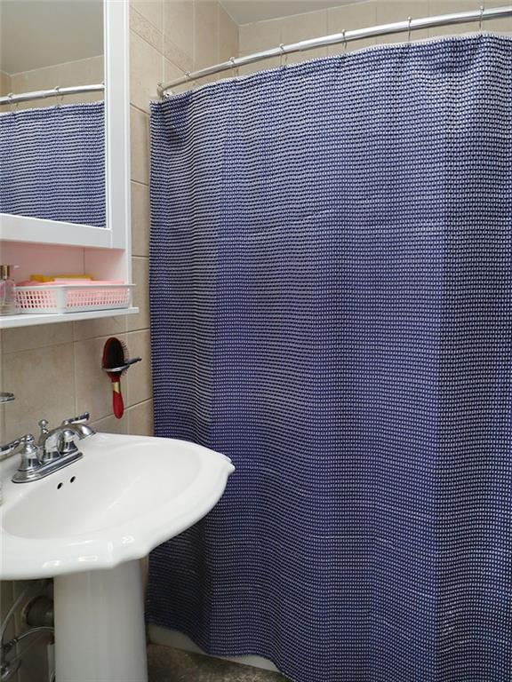 643 Morgan Avenue Brooklyn, NY 11222 - Photo 8 of 50 a bathroom with a sink and a mirror