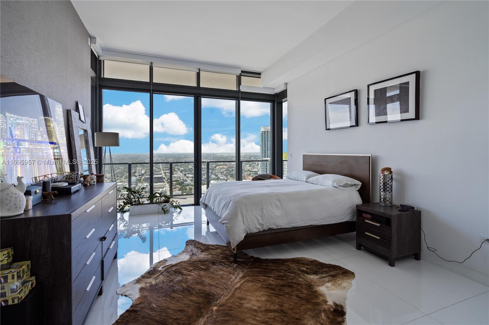 88 Southwest 7th Street, Unit 4203 Miami, FL 33130 - Photo 73 of 96 a bedroom with a large bed and a large window