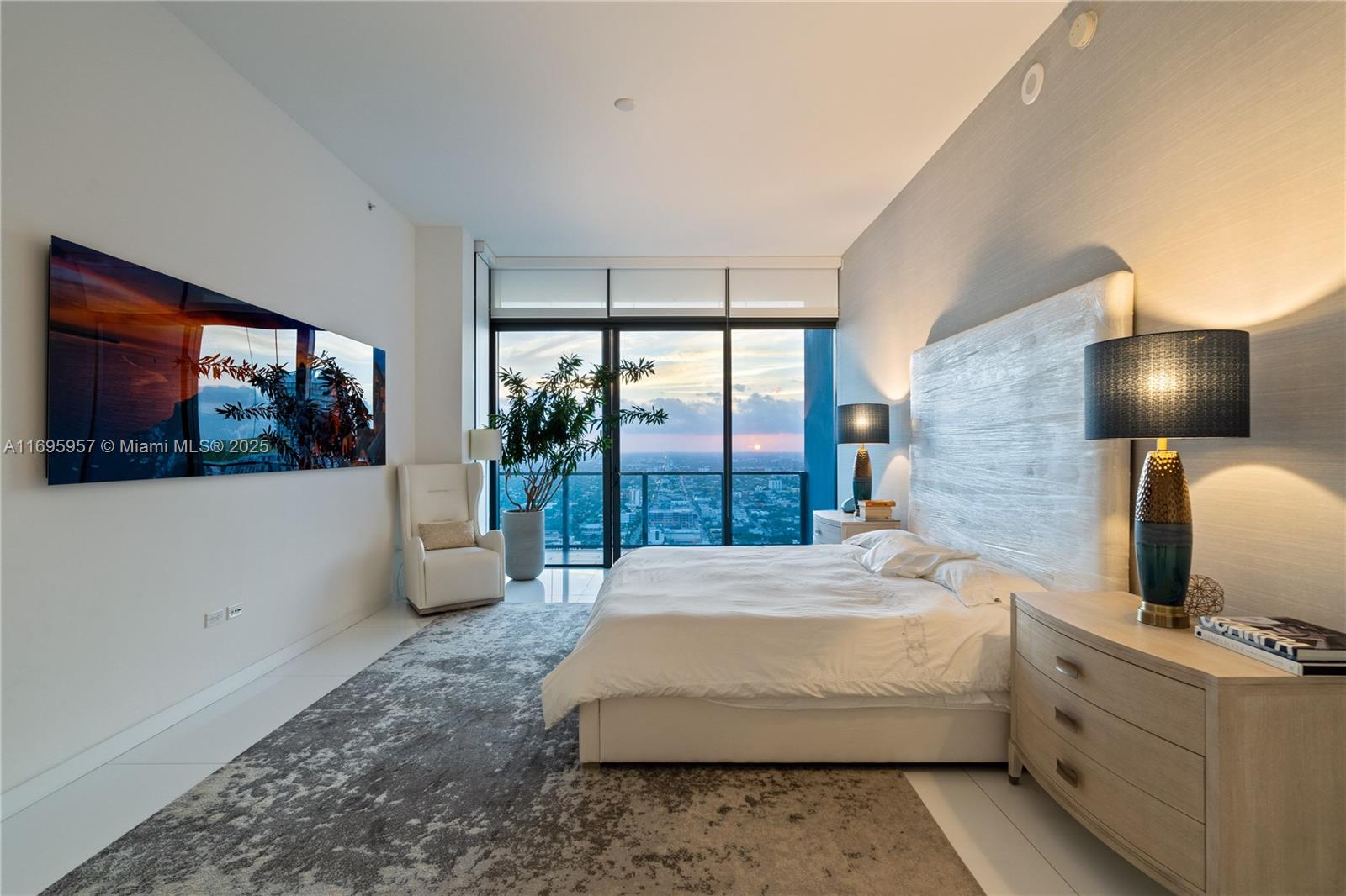 88 Southwest 7th Street, Unit 4203 Miami, FL 33130 - Photo 96 of 96 a bedroom with a large bed and a large window