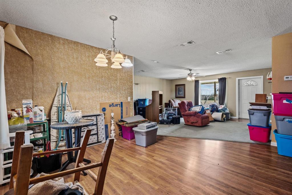 1841 County Road Honey Grove, TX 75446 - Photo 15 of 32 a living room with furniture and a chandelier