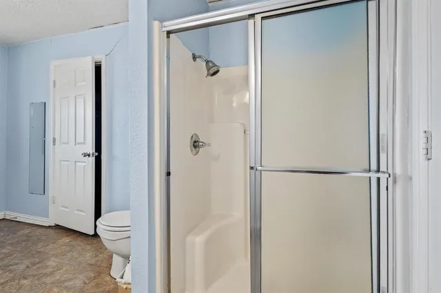 a view of hallway with cabinets and furniture
