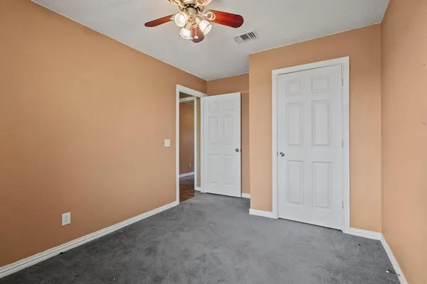 a room with a window and ceiling fan
