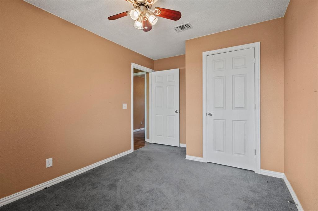 1841 County Road Honey Grove, TX 75446 - Photo 4 of 32 an empty room with a chandelier fan