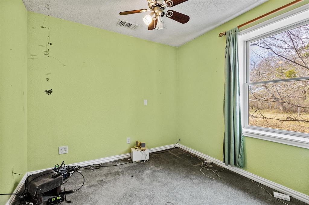 1841 County Road Honey Grove, TX 75446 - Photo 5 of 32 a room with a window and ceiling fan