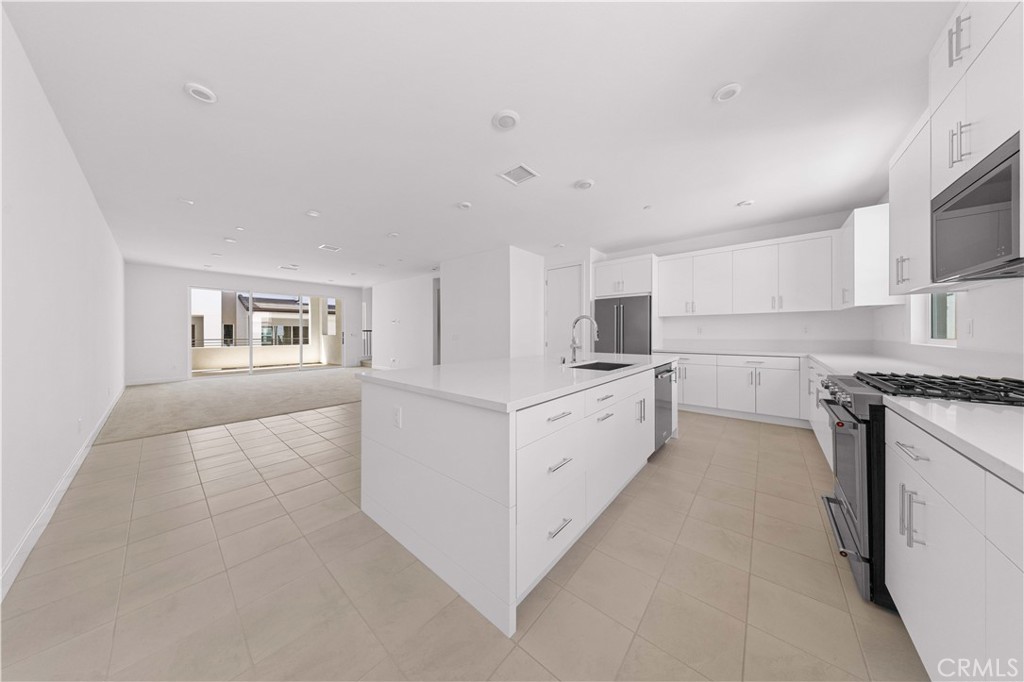 a kitchen with white cabinets and white appliances