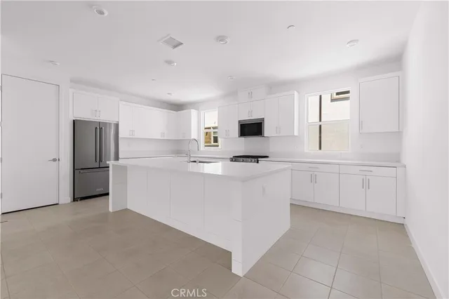 a kitchen with cabinets and white appliances
