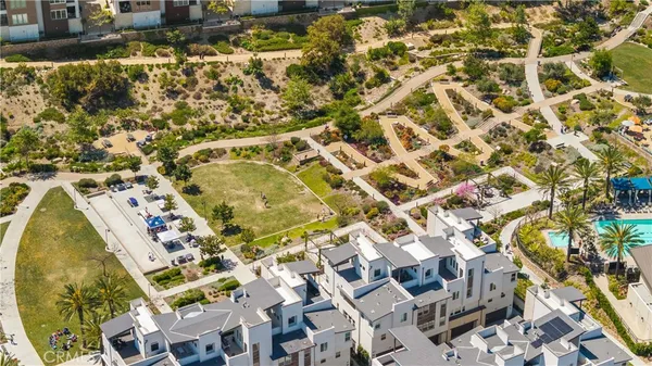 an aerial view of residential houses with outdoor space