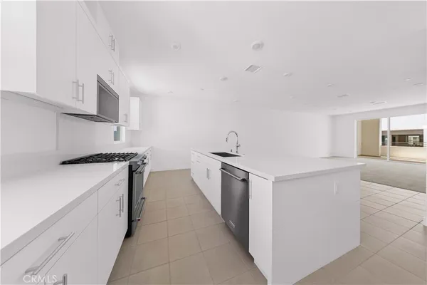 a kitchen with a stove and a refrigerator