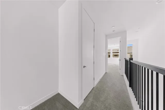 a view of a hallway with a wooden floor