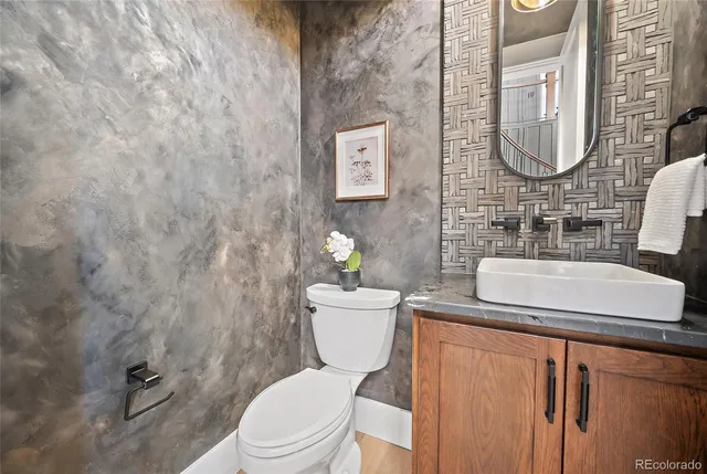 a bathroom with a toilet a sink and mirror
