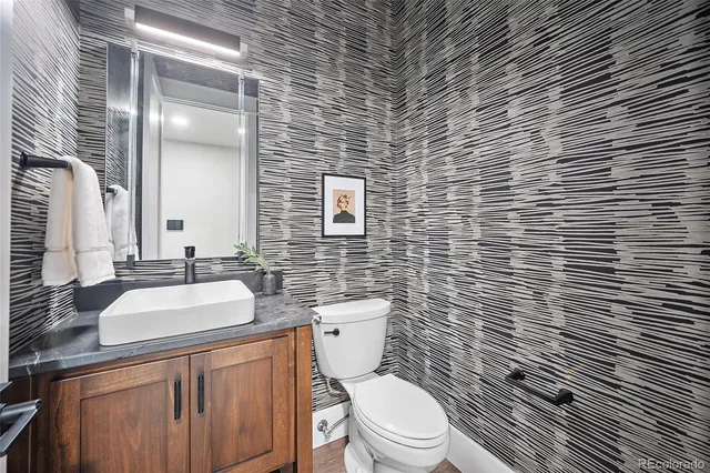 a bathroom with a toilet a sink and mirror