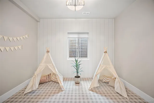 a view of a room with wooden floor and windows