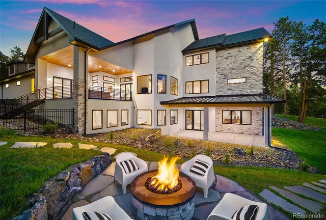 an aerial view of a house with a yard pool a patio and outdoor seating