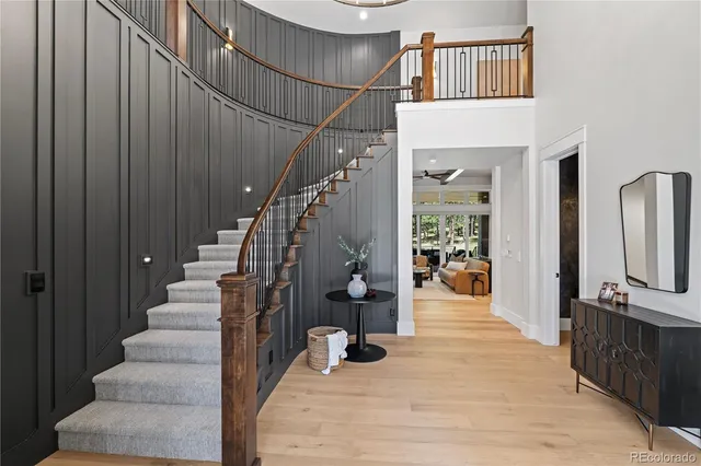 a view of entryway and hall with wooden floor