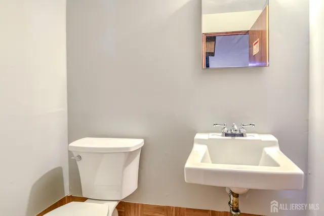 a white toilet sitting next to a white sink