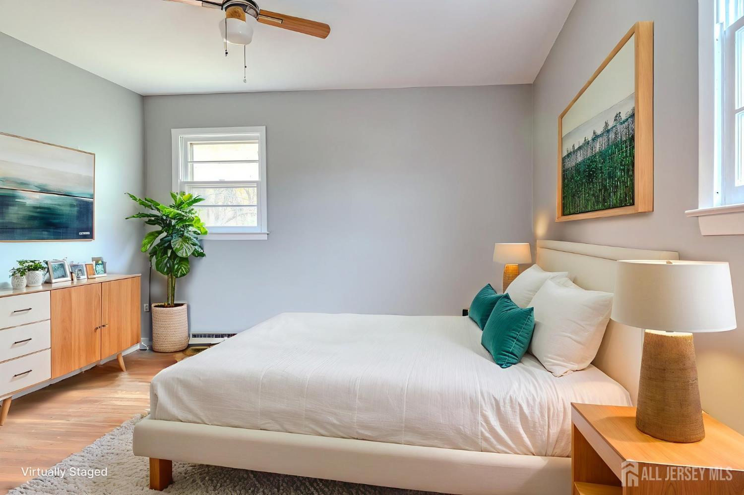 347 Lincoln Boulevard Middlesex, NJ 08846 - Photo 19 of 25 a bedroom with a large bed and a flat tv screen on dresser