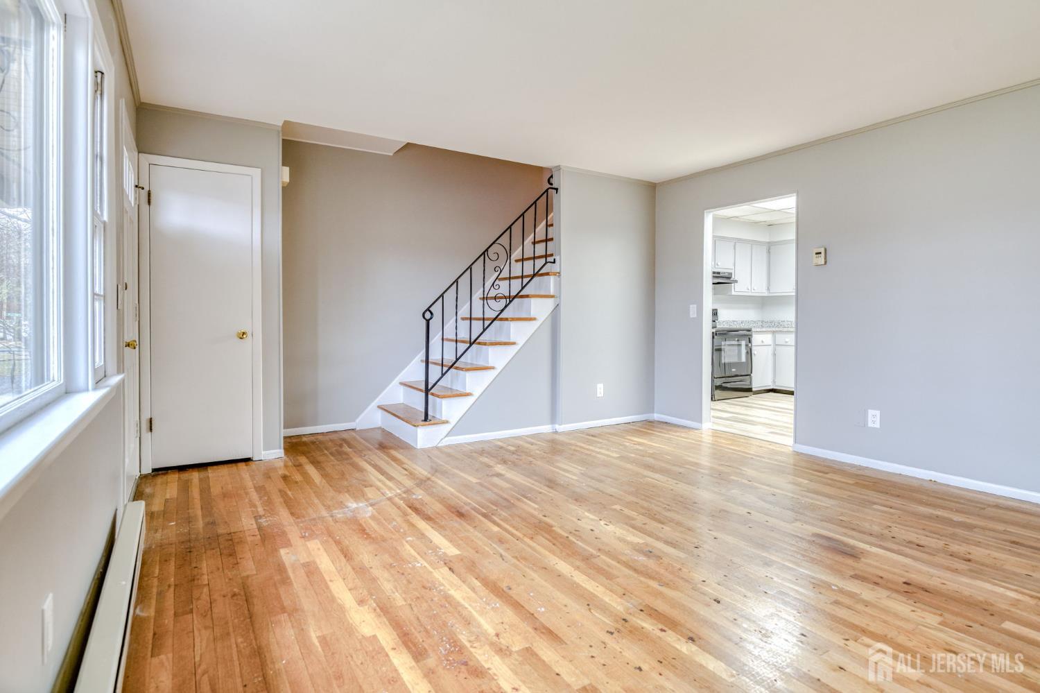 347 Lincoln Boulevard Middlesex, NJ 08846 - Photo 4 of 25 a view of an empty room with wooden floor and stairs