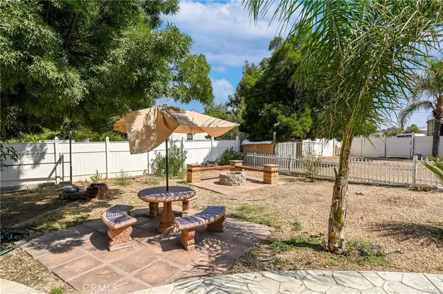 a view of a patio with chairs and potted plants