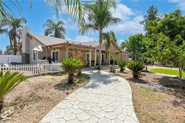 a view of a house with a swimming pool and sitting area
