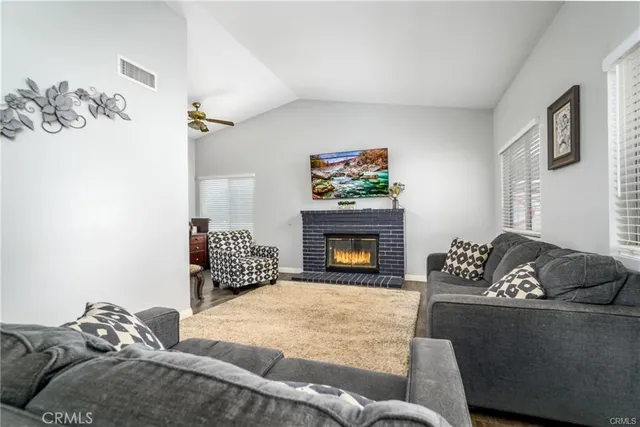 a living room with furniture and a fireplace