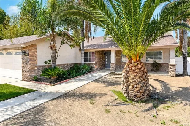 a front view of a house with a garden