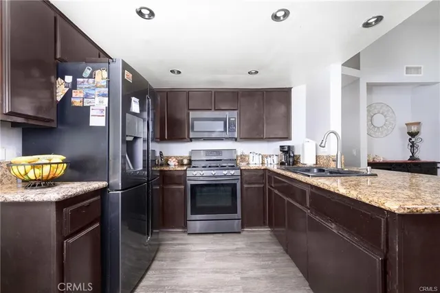 a kitchen with granite countertop stainless steel appliances and counter space