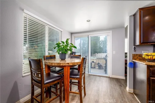 a dining room with furniture and wooden floor