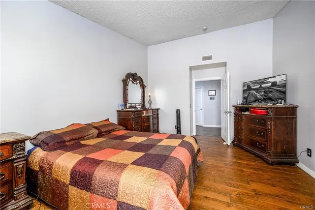 a bedroom with a bed and a television