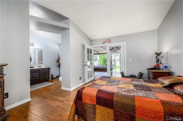 a bedroom with a bed and a large mirror