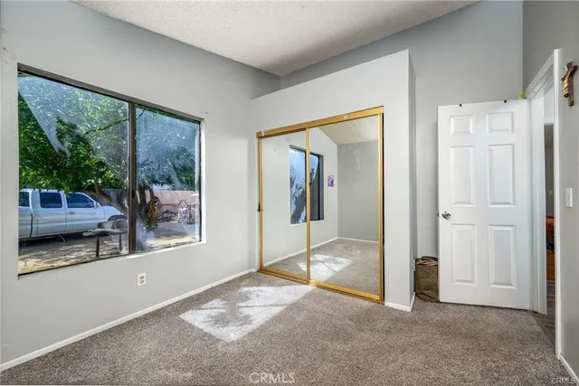 a bedroom with a bed and dresser