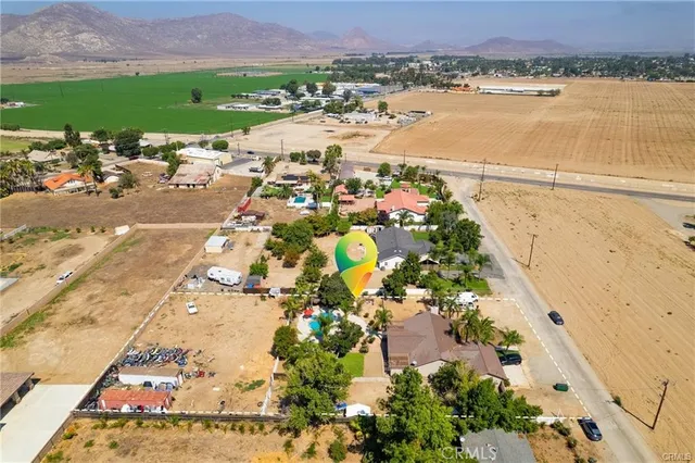 an aerial view of ocean and residential houses with outdoor space
