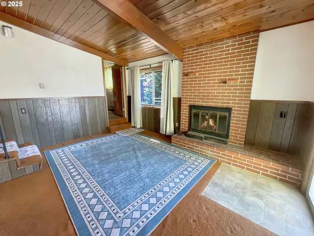 a living room with furniture rug and a fireplace