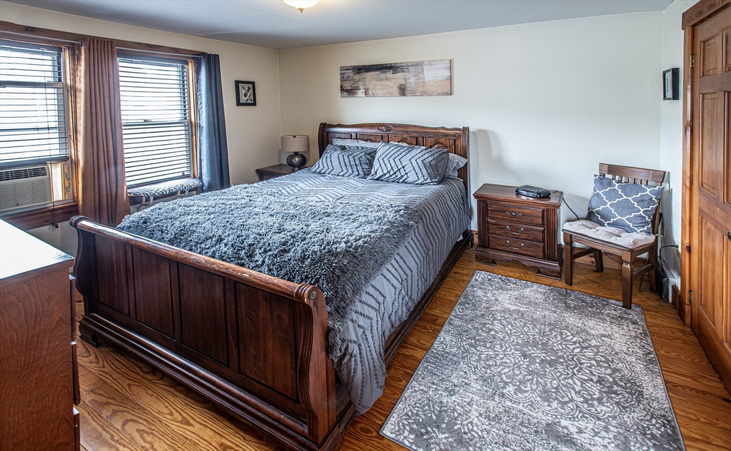 104-106 Everett Street Easthampton, MA 01027 - Photo 16 of 28 a bed sitting in a bedroom next to a window