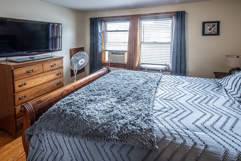 104-106 Everett Street Easthampton, MA 01027 - Photo 17 of 28 a bedroom with a bed and a flat screen tv