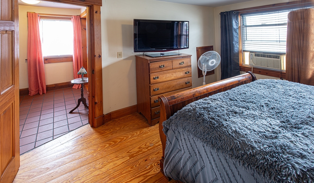 104-106 Everett Street Easthampton, MA 01027 - Photo 18 of 28 a bedroom with a bed and a flat tv screen on dresser