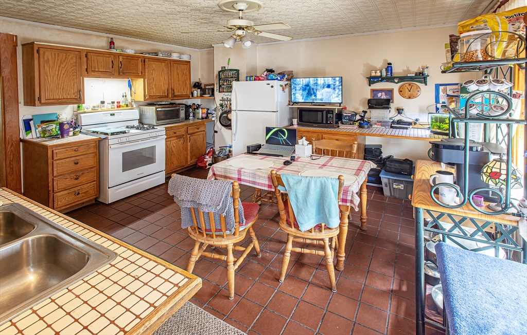 104-106 Everett Street Easthampton, MA 01027 - Photo 22 of 28 a kitchen with stainless steel appliances kitchen island granite countertop a refrigerator and microwave