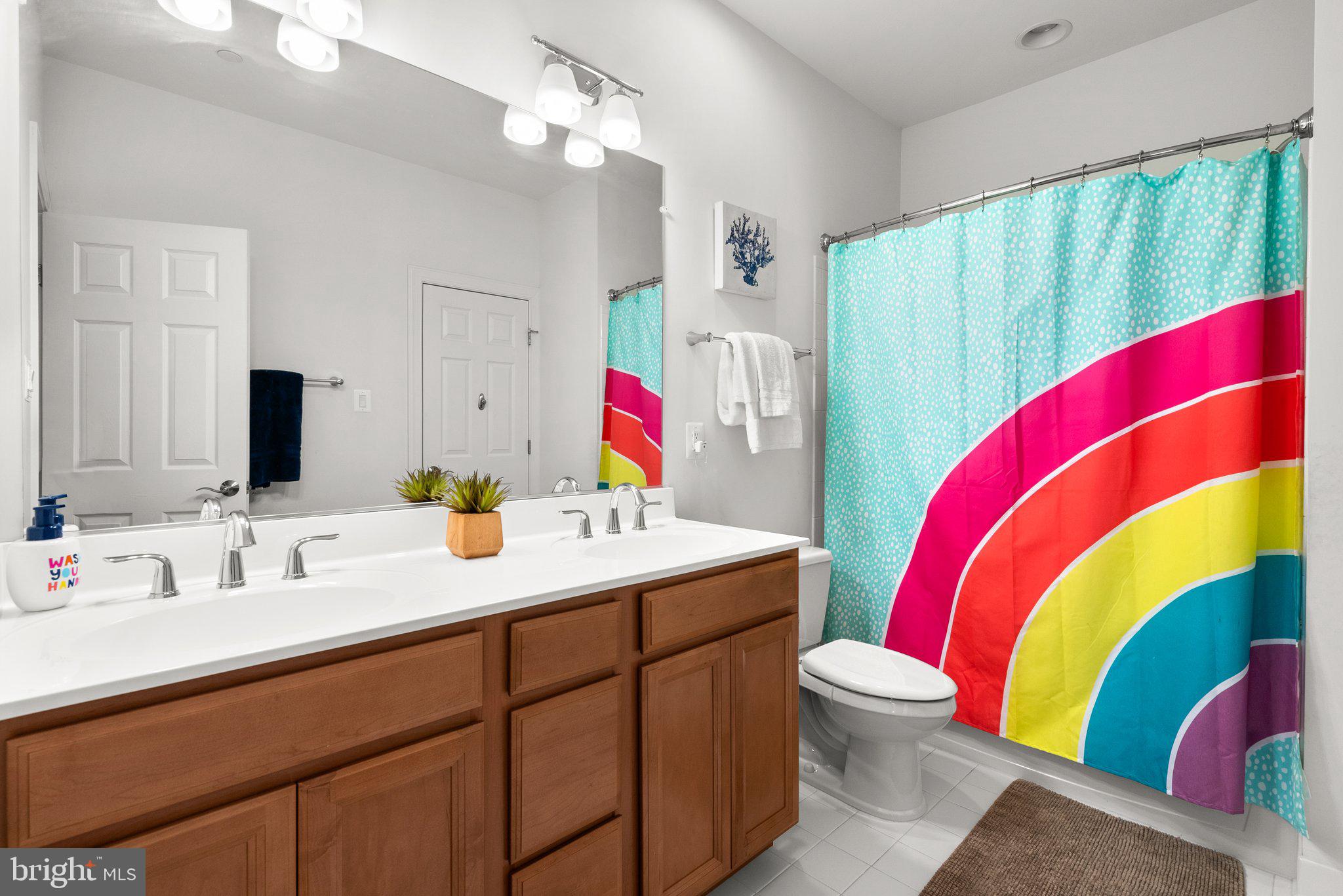 18608 Compher Court Poolesville, MD 20837 - Photo 19 of 40 a bathroom with a sink vanity mirror and toilet