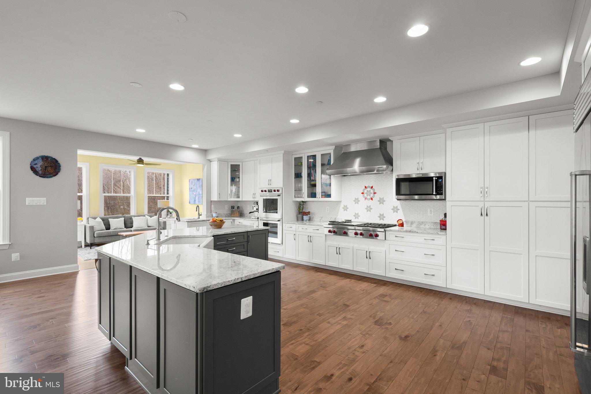18608 Compher Court Poolesville, MD 20837 - Photo 7 of 40 a large kitchen with kitchen island a sink a stove and a refrigerator