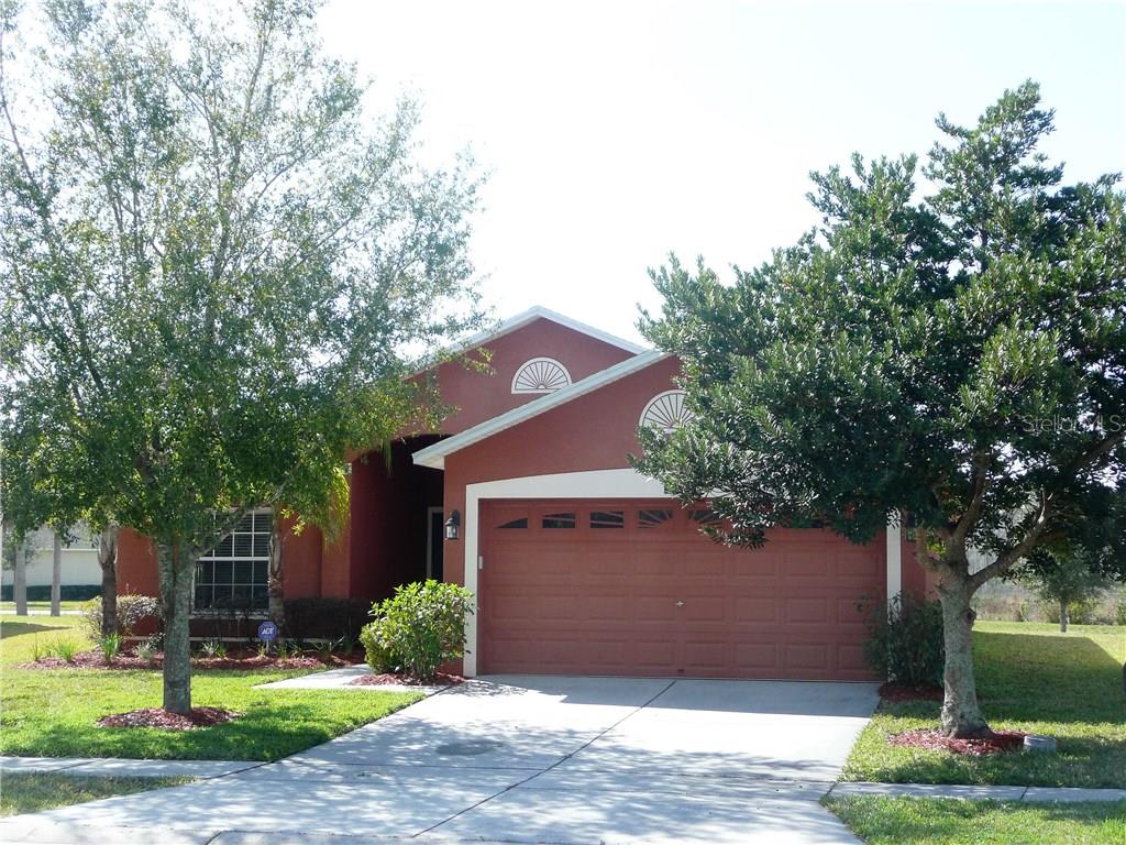 3905 Constantine Loop Wesley Chapel, FL 33543 - Photo 1 of 1 Stately trees, flower beds and striking rich coloring invite you to stop and take a look at this beautiful house that could just be your new home!