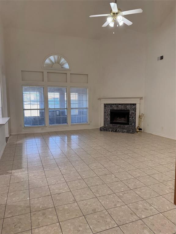 5817 Mulvane Drive Plano, TX 75094 - Photo 14 of 39 an empty room with fireplace and windows