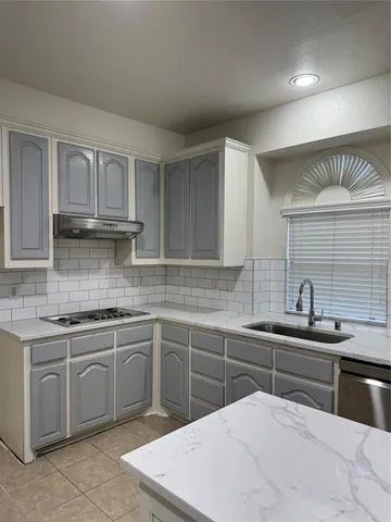 a kitchen with a sink and cabinets